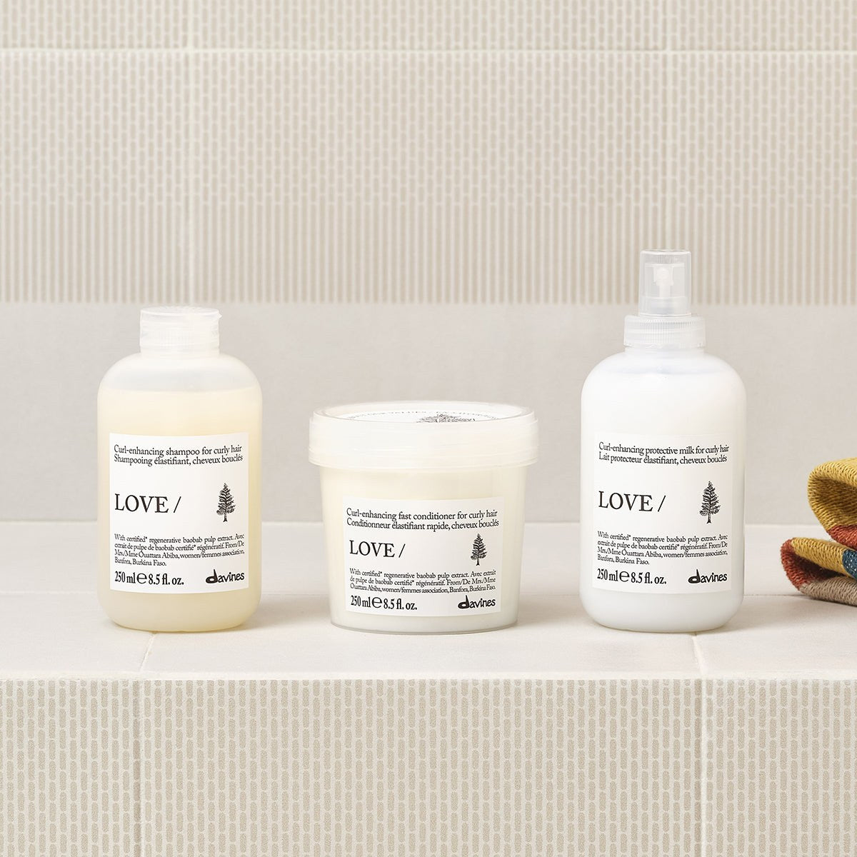 Davines LOVE Curl Conditioner with the LOVE Curl range on a bathroom shelf